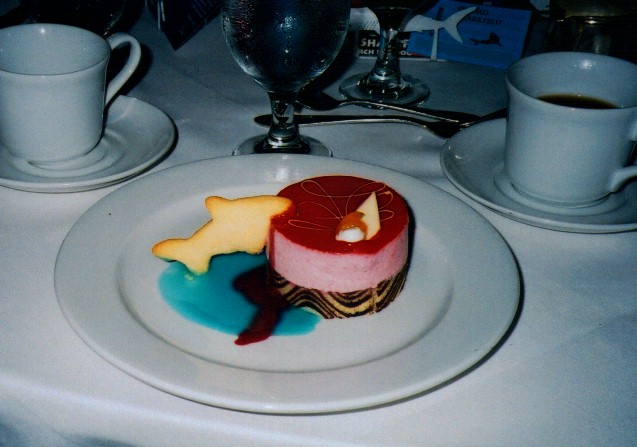 raspberry mousse hockey puck with shark cookie biting it